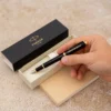hand holding parker pen with the box